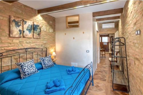 a bedroom with a blue bed in a room at Il Girasole -with Garden- in Buonconvento