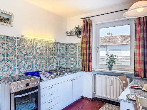 a kitchen with a sink and a window at Apartment Alpenseeblick by Interhome in Seebruck