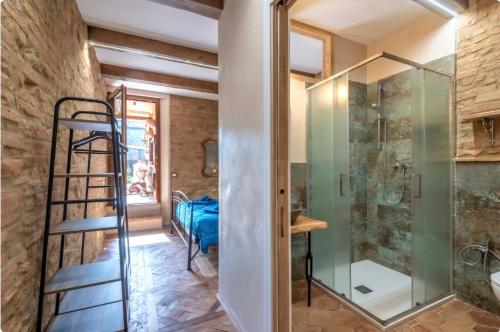 a bathroom with a walk in shower and a glass shower stall at Il Girasole -with Garden- in Buonconvento