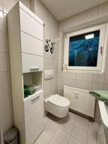 a bathroom with a toilet and a window at Ferienwohnung Hopfentraum in Alpirsbach
