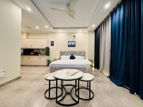 a bedroom with a bed and two tables in a room at Stay Premium in Islamabad