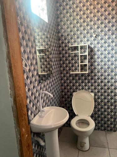 a bathroom with a toilet and a sink at Meu cantinho 5 in Santarém