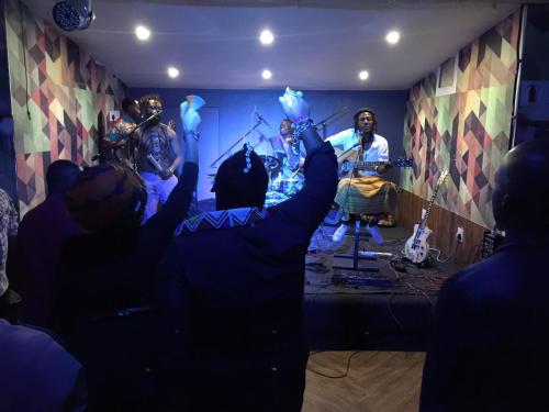 a group of people watching a band in a room at Bannister Hotel in Johannesburg