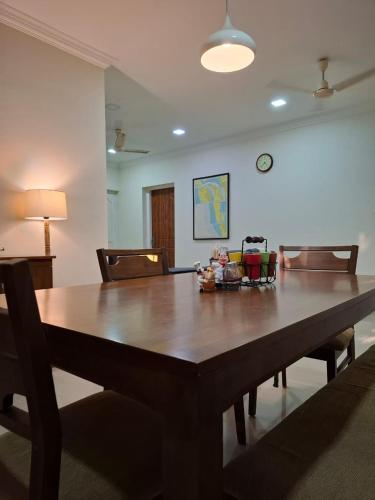 a large wooden table in a living room at The Beach House in Cochin