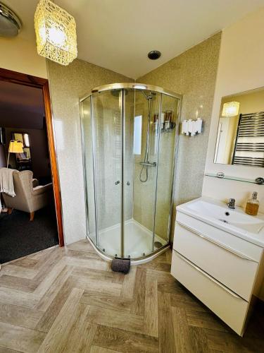 a bathroom with a shower and a sink at SEAcroft Licensed B&B and Restaurant in Aird Uig