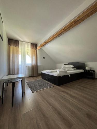 a bedroom with a bed and a table in it at Eva House in Ciocăneşti