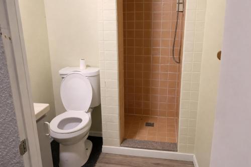 a bathroom with a toilet and a shower at Hoover Homes for the Soul in Los Angeles