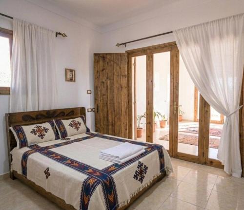 a bedroom with a bed and a large window at Lalibela Circle Guest House in Lalibela
