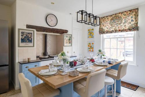 a kitchen with a table with chairs and a dining room at Luxury House - Walk to Racecourse - Sleeps 10 in Chester