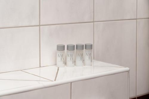 a shelf with three bottles on it in a bathroom at Villa Juric 2 in Baška Voda