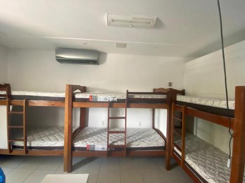a room with three bunk beds in a room at Hostel Suites in Recife