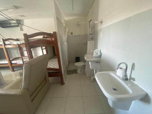 a bathroom with a sink and a bunk bed at Hostel Suites in Recife