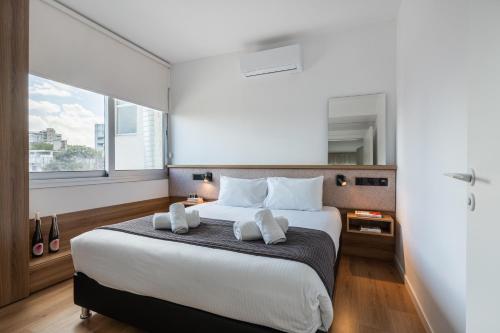 a bedroom with a large bed with two white pillows at Cozy luxury 1-bedroom in Nicosia’s heart in Nicosia