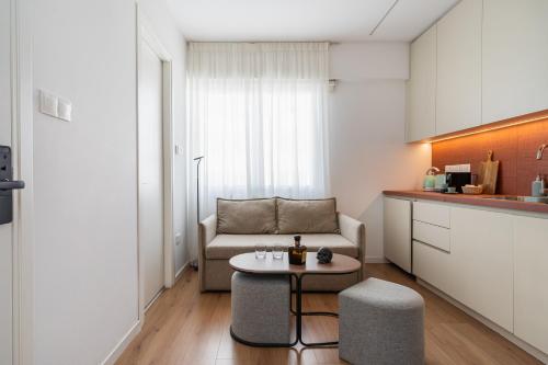 a living room with a couch and a table at Cozy luxury 1-bedroom in Nicosia’s heart in Nicosia
