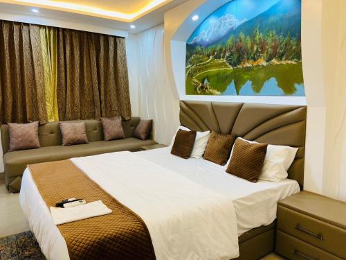 a bedroom with a large bed and a couch at The Starfish Studio in Dehradun