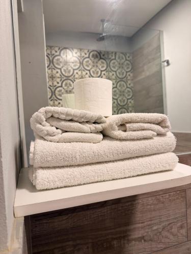 a pile of towels sitting on a shelf in a bathroom at Espacios Plaza VM in Villa María