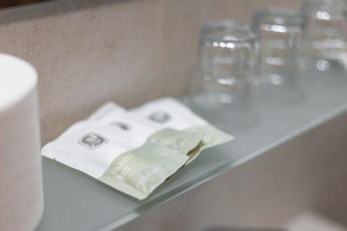 a white table with glasses and a napkin on it at Oaza Ricany in Ricany