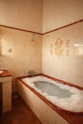 a large bath tub in a bathroom with at Auralis Experience in Jigani