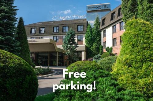 a sign that reads free parking in front of a building at Booking Hotel & Spa in Krakow