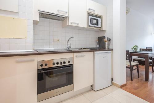 a kitchen with a sink and a stove top oven at GuestReady - Domocenter studio with garage in Bormujos
