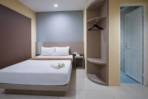a bedroom with a bed and a walk in shower at Tentrem BS Residence in Semarang