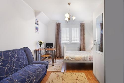 a living room with a couch and a bed at Apartamenty Nadmorskie in Rewa