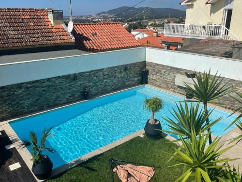 a swimming pool on the roof of a house at Moradia Com Piscina T4 in Esposende