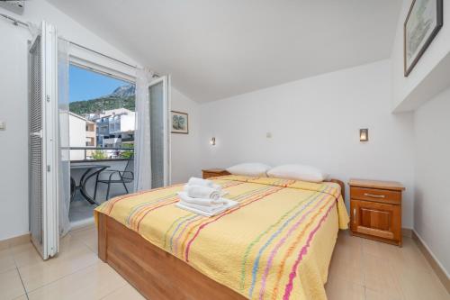 a bedroom with a bed and a balcony at Villa Juric 2 in Baška Voda