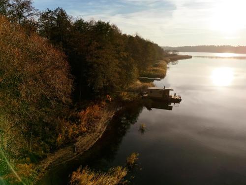 an aerial view of a river with a boat in it at Houseboat Pałuki in Sobiejuchy