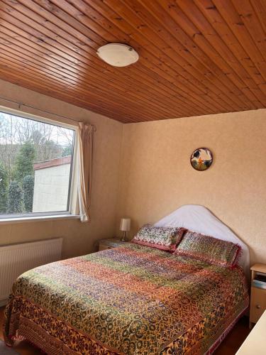 a bedroom with a bed and a window at The Wild Atlantic Hideaway in Inch