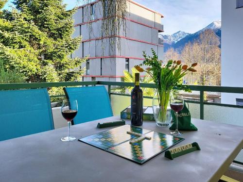 a table with a bottle of wine and a glass at Apartment Apt- Hermosa by Interhome in Locarno
