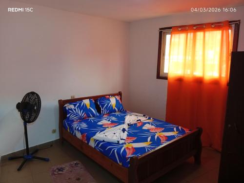 una camera da letto con un letto e una finestra di Shine town house a Yaoundé