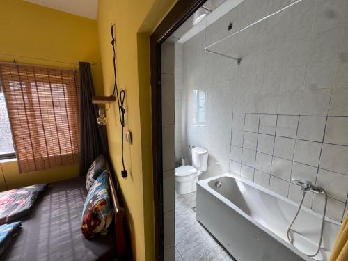 a bathroom with a bath tub and a toilet at Roof Top Hostel in Tirana