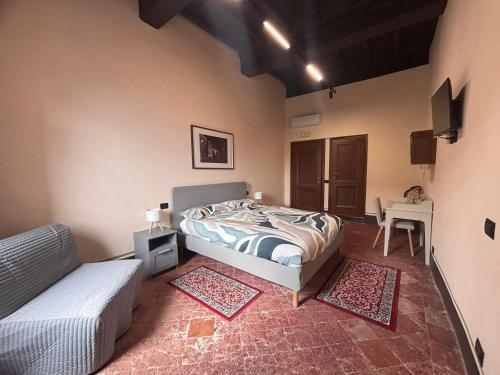 a bedroom with a bed and a chair and a table at Barberini Guest House Palestrina in Palestrina
