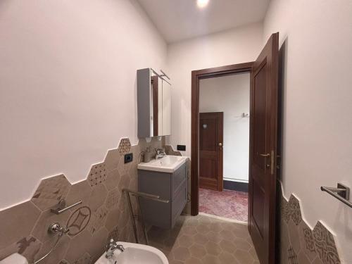 a bathroom with a toilet and a sink and a mirror at Barberini Guest House Palestrina in Palestrina