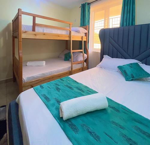 a bedroom with two bunk beds and a window at COZY Two BEDROOM in Bamburi