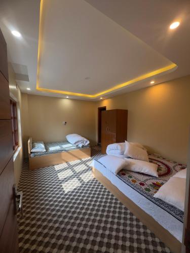 a bedroom with two beds in a room at Shrestha Hotel And Lodge in Dhāding