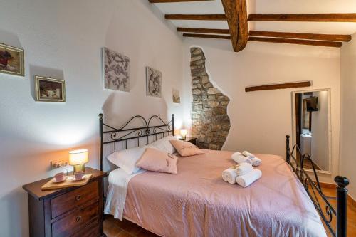 a bedroom with a bed with two stuffed animals on it at GuestHost - Lavanda Apartment with Pool & Parking in Passignano sul Trasimeno
