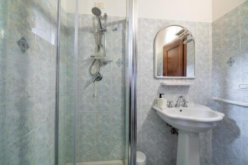 a bathroom with a shower and a sink at GuestHost - Lavanda Apartment with Pool & Parking in Passignano sul Trasimeno
