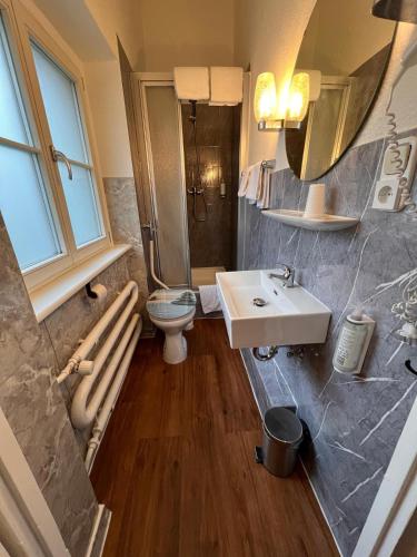 a bathroom with a sink and a toilet at Hotel Galleria in Munich