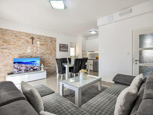 a living room with a couch and a table at Apartment Dijana by Interhome in Donji Proložac