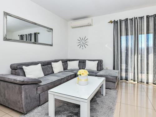 a living room with a couch and a table at Apartment Dijana by Interhome in Donji Proložac