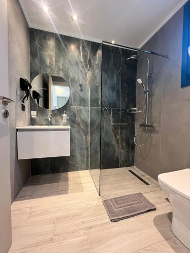 a bathroom with a shower and a sink at Ampelitis Studios Lemnos in Agios Ioannis Kaspaka
