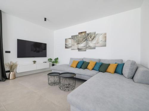 a white living room with a couch and a tv at Villa Magic Sky 1 by Interhome in Kraj