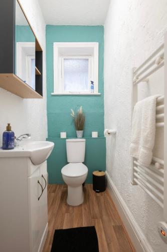 a bathroom with a white toilet and a sink at Seafront Flat in Brighton Marine Parade in Worthing