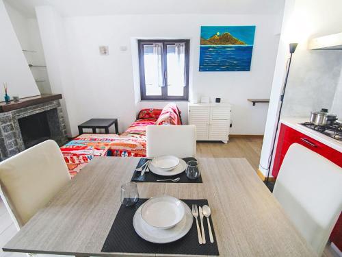 a dining room with a table and a living room at Apartment Amarena by Interhome in Dormelletto