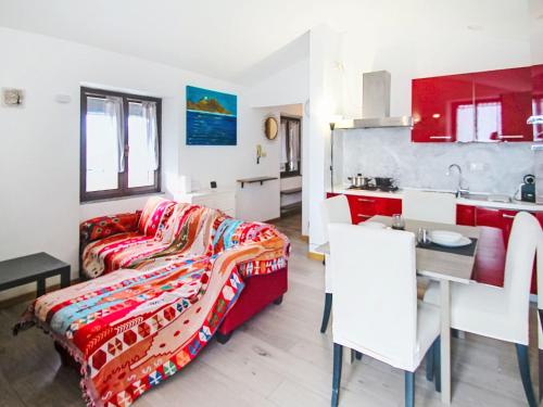 a living room with a couch and a kitchen at Apartment Amarena by Interhome in Dormelletto