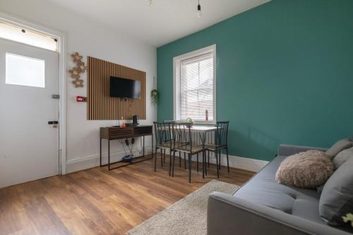 a living room with a couch and a table at Seafront Flat in Brighton Marine Parade in Worthing