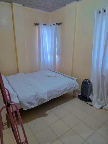 a small bedroom with a bed and a window at Executive 1bedroom Embu by Tsparks in Embu