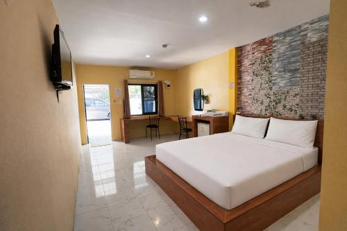 a bedroom with a bed and a television in it at FHR Krabi City Hotel in Krabi